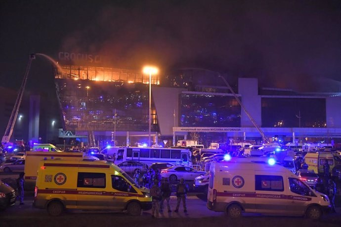 MOSCOW, March 22, 2024  -- Rescuers work near the burning Crocus City Hall concert venue following a shooting incident in the northwest of Moscow, Russia, on March 22, 2024. At least 40 people were killed and more than 100 injured after a shooting at the 