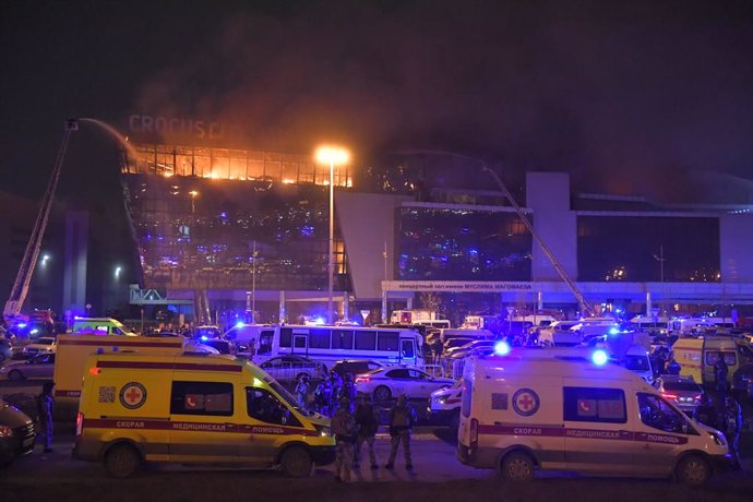 MOSCOW, March 22, 2024  -- Rescuers work near the burning Crocus City Hall concert venue following a shooting incident in the northwest of Moscow, Russia, on March 22, 2024. At least 40 people were killed and more than 100 injured after a shooting at th