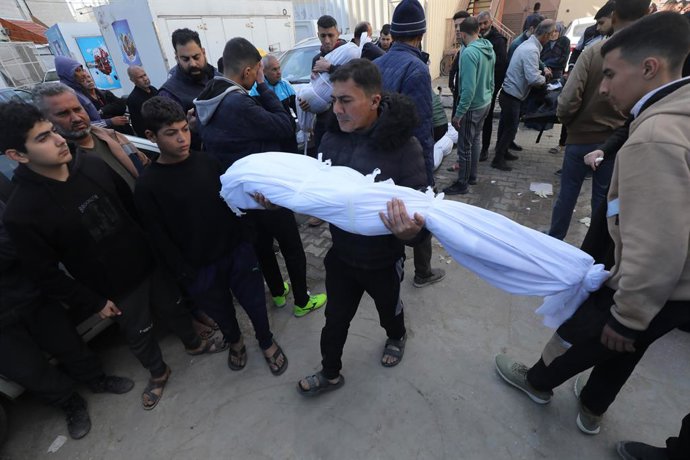 March 25, 2024, Dair El-Balah, Gaza Strip, Palestinian Territory: Relatives of the Palestinians died in Israeli attacks, mourn as they receive the dead bodies of the Salman and Al-Buhaisi family from the morgue of Al-Aqsa Hospital for burial in Dair El-Ba