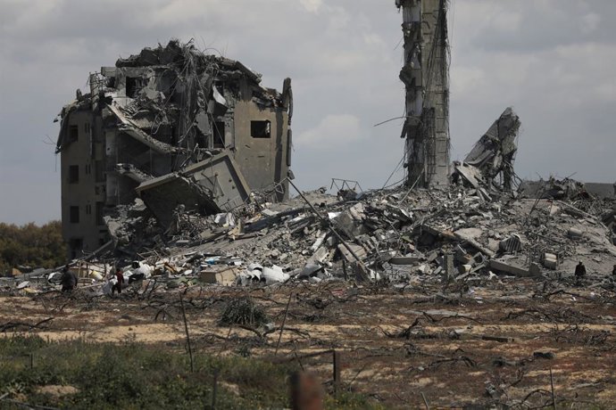 March 25, 2024, Nuseirat, Gaza Strip, Palestinian Territory: People search the rubble of destroyed buildings in the Asra residential compound, northwest of Nuseirat in the Gaza Strip, on March 25, 2024