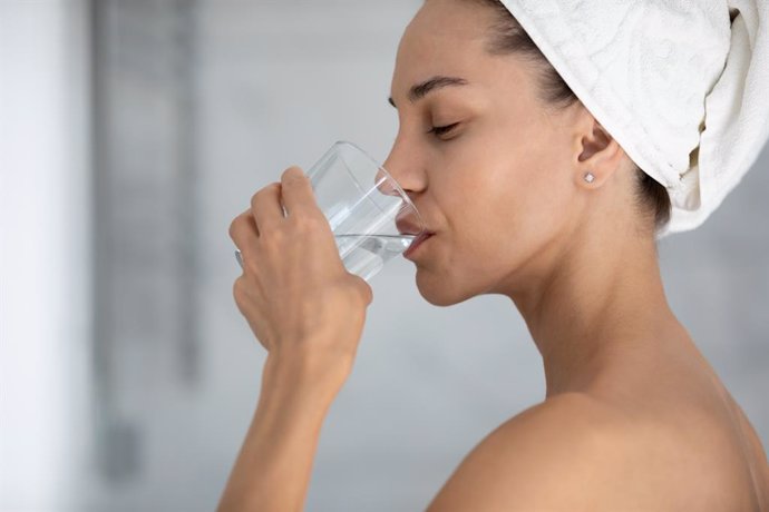 Archivo - Mujer bebiendo agua mineral.