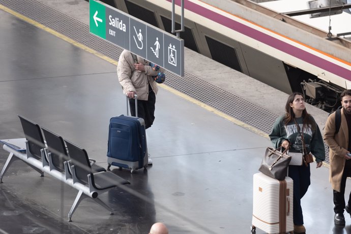 Varias personas caminan con maletas en uno de los andenes de la estación de Atocha, a 22 de marzo de 2024, en Madrid (España). 