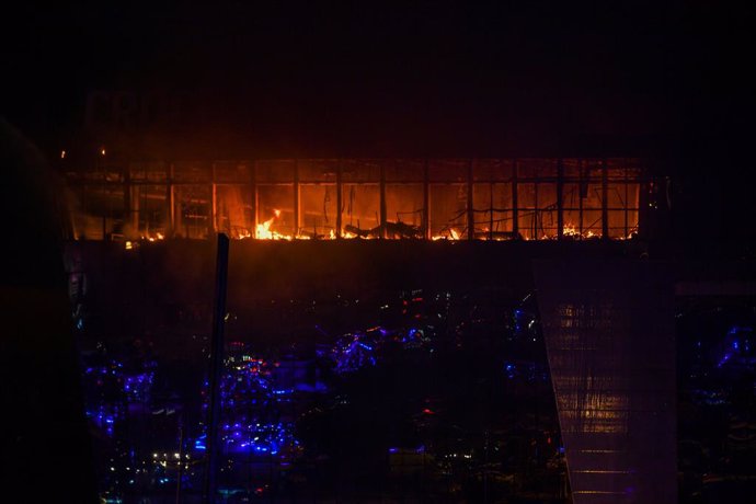 MOSCOW, March 22, 2024  -- Smoke from fire rises above the burning Crocus City Hall concert venue following a shooting incident in the northwest of Moscow, Russia, on March 22, 2024. At least 40 people were killed and more than 100 injured after a shootin