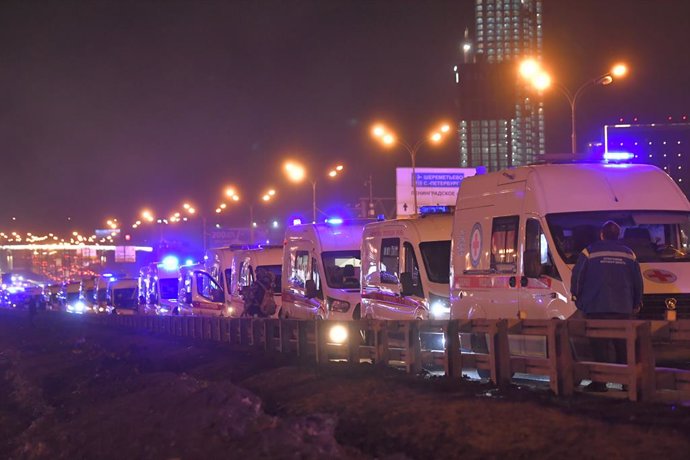 MOSCOW, March 22, 2024  -- Ambulances are seen near the Crocus City Hall concert venue following a shooting incident in the northwest of Moscow, Russia, on March 22, 2024. At least 40 people were killed and more than 100 injured after a shooting at the Cr