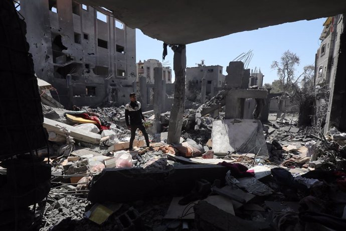 March 20, 2024, Nuseirat, Gaza Strip, Palestinian Territory: Palestinians search for survivors amid the rubble of buildings destroyed after deadly Israeli attacks in Nuseirat Refugee Camp in the central part of Gaza.