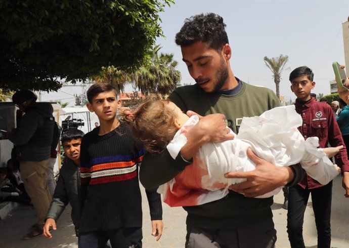 March 27, 2024, Dair El-Balah, Gaza Strip, Palestinian Territory: Relatives of A Palestinian Child, Yasmeen Abu Rkab, 2, died in Israeli attacks, mourn as they receive her body from the morgue of Al-Aqsa Hospital for burial in Dair El-Balah, Gaza on March