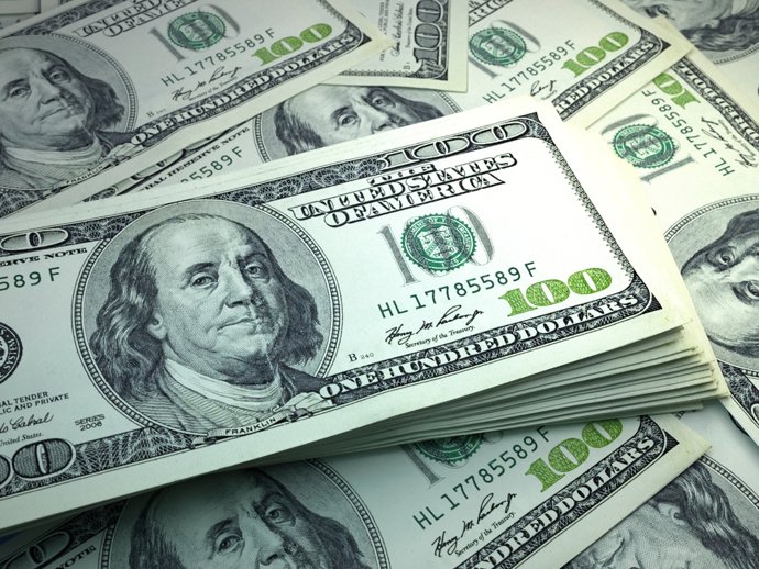 Archivo - January 21, 2024: Money of United States. United States dollar bills. USD banknotes. 100 dollars. Business, finance, news background. 3d illustration.