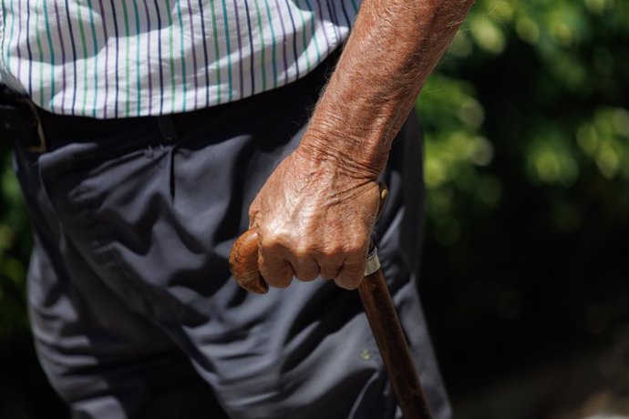 Archivo - Un home gran passeja recolzant-se en un bastó