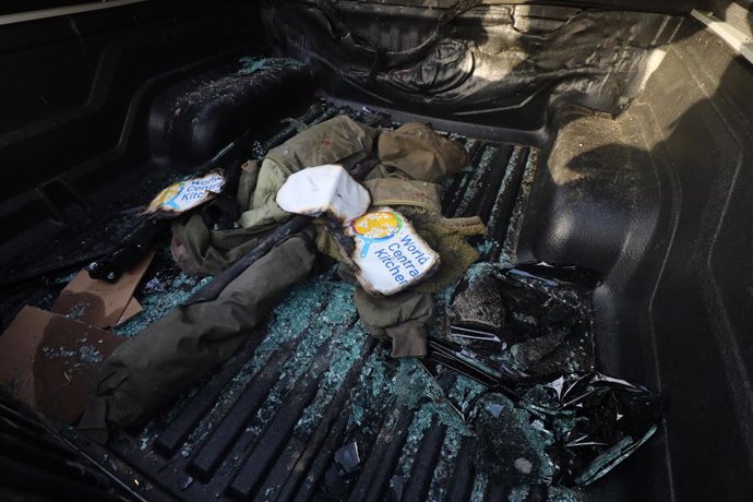 April 2, 2024, Dair El-Balah, Gaza Strip, Palestinian Territory: Palestinians inspect the heavily damaged vehicles after the Israeli attacks target officials working at the US-based international volunteer aid organization World Central Kitchen (WCK), in 