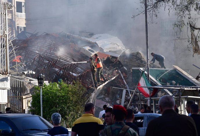 DAMASCUS, April 2, 2024  -- Rescuers work at the site of an Israeli missile attack targeting the building of the Iranian Consulate in Damascus, Syria, April 1, 2024. At least five people, including a senior Iranian commander, were killed in Israeli airstr