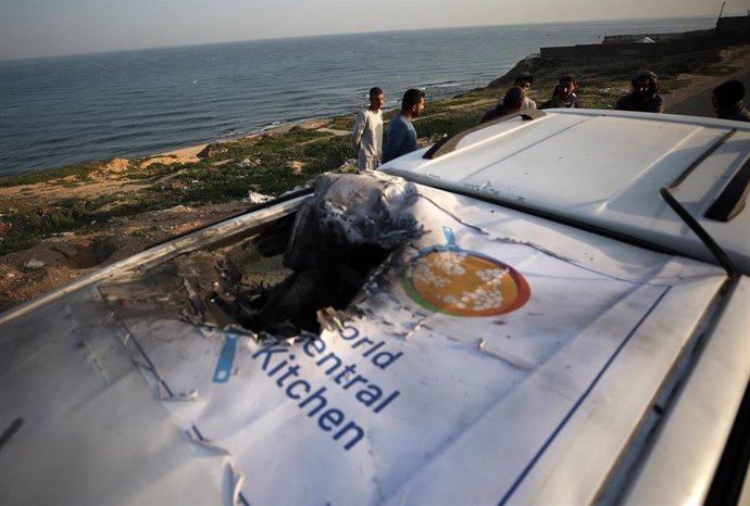 DEIR EL-BALAH, April 2, 2024  -- Palestinians check a damaged vehicle after Israeli strikes in central Gaza Strip city of Deir el-Balah, on April 2, 2024. Israel on Tuesday assumed responsibility for the killing of seven workers of international food char