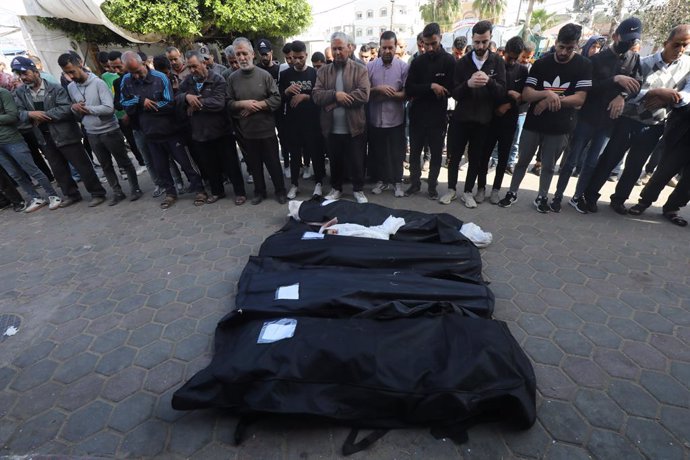 April 3, 2024, Dair El-Balah, Gaza Strip, Palestinian Territory: Relatives and Palestinians perform funeral prayer of Palestinians killed in Israeli attack hit the houses belonging to the Shaheen family at the Al-Aqsa Martyrs Hospital as Israel's air, lan