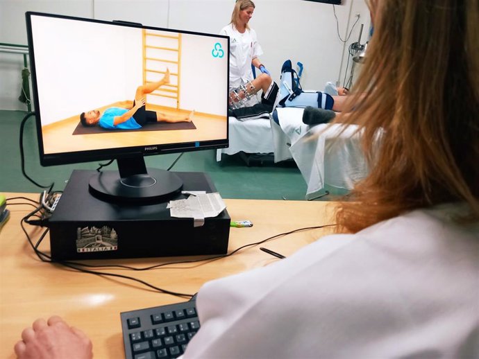 Una fisoterapeuta utiliza una plataforma digital para atender a pacientes.