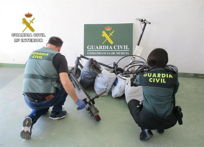 Dos agentes de la Guardia Civil junto a parte del material intervenido en el marco de la la operación 'Civeta'