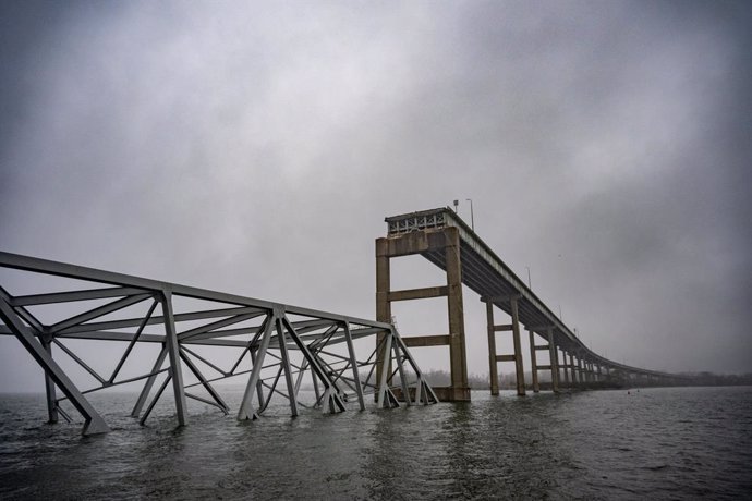 April 2, 2024, Baltimore, MD: A collapsed section of the Francis Scott Key Bridge is seen in the fog on the southwest side of the Patapsco River on Tuesday, April 2, 2024. A week ago the container ship Dali hit a structural pier causing a subsequent colla