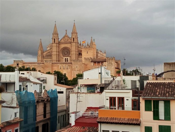 Archivo - Vista de la Catedral de Mallorca, sobre un barrio de Palma, en un día nublado.