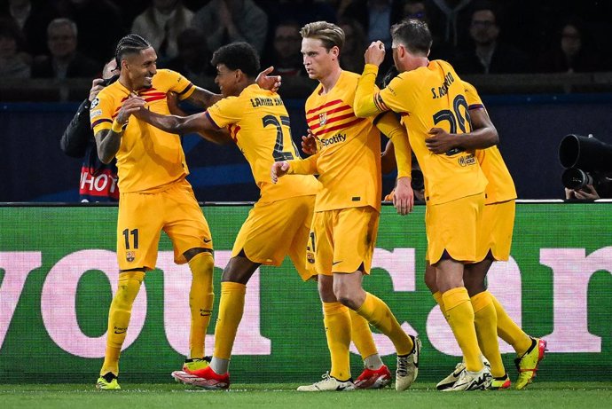 10 April 2024, France, Paris: Barcelona Raphina (L) celebrates after scoring his side's goal during the UEFA Champions League quarter-finals first leg soccer match between Paris Saint-Germain and FC Barcelona at Parc des Princes stadium. Photo: Matthieu M