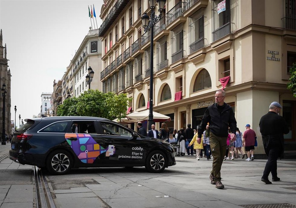 Un vehículo VTC circula por una calle del centro de Sevilla. 