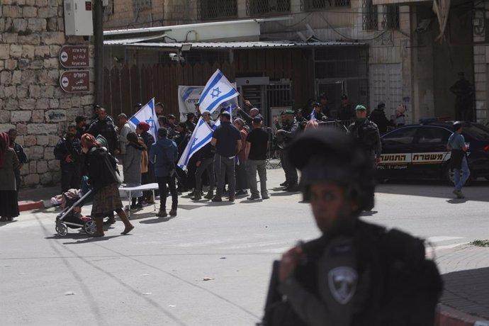 March 15, 2024, Hebron, West Bank, Palestinian Territory: Jewish settlers, gathering in the area with Israeli flags, protested the opening of the checkpoint and letting the Palestinians to prayer there as Palestinians in the West Bank city of Hebron perfo