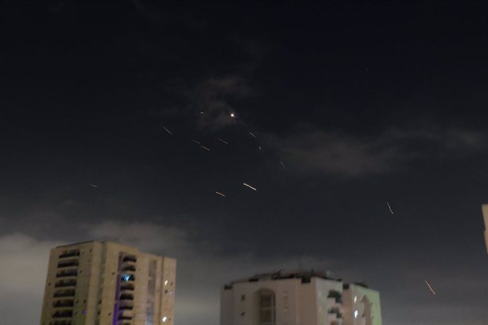 TEL AVIV, April 14, 2024  -- This photo taken on April 14, 2024 shows flares from explosions in the sky over Tel Aviv as Israel's anti-missile system intercepts missiles and drones from Iran. A combined attack of dozens of ballistic missiles and hundreds 