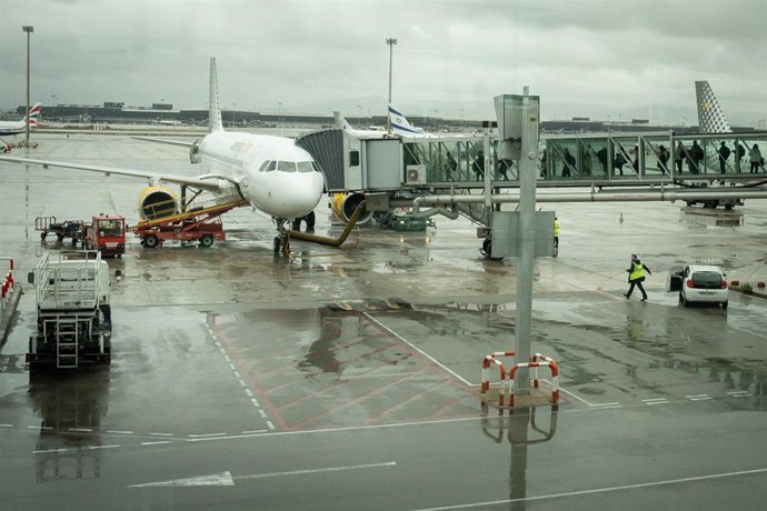 Archivo - Un avión aparcado en la pista del aeropuerto de El Prat.