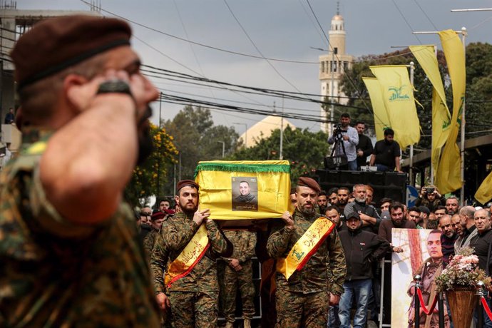 April 8, 2024, Beirut, Beirut, Lebanon: Pro-Iranian Hezbollah militants carry the coffin of the party senior commander ALI AHMAD HUSSEIN, who was killed in an overnight Israeli air raid in south Lebanon, during his funeral procession in Beirut southern su