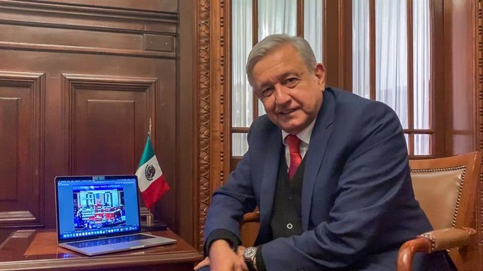 Archivo - 19 December 2019, Mexico, Mexico City: Mexican President Andres Manuel Lopez Obrador is pictured as he follows on a laptop the session of the US House of Representatives where they approved the United States-Mexico-Canada Agreement (T-mec) 