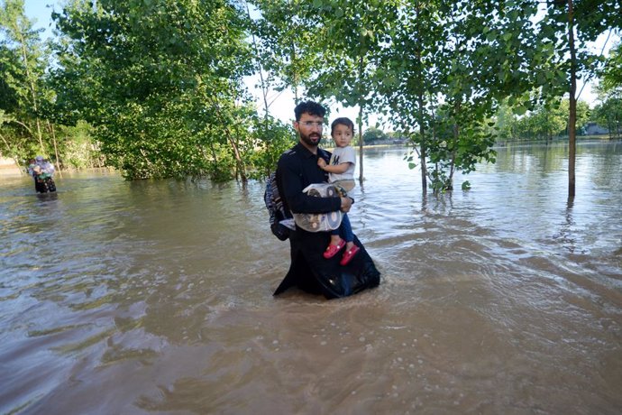 April 17, 2024, Peshawar, Peshawar, Pakistan: Heavy rains and floods kill dozens in Pakistan's southwest...PESHAWAR, PAKISTAN - APRIL 16: People wade through a flooded street after heavy rain in Nowshera District, Khyber Pakhtunkhwa province, Pakistan, 16