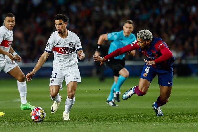 Warren Zaire-Emery of PSG and Ronald Araujo of FC Barcelona in action during the UEFA Champions League, Quarter-final Second Leg, match played between FC Barcelona and Paris Saint-Germain FC at Estadio Olimpico de Montjuic on April 16, 2024, in Barcelona,