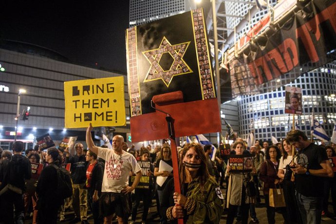March 30, 2024, Tel Aviv, Israel: An Israeli protestors hold up a placard with the Star of David made from the Israeli hostage's photos painted with red. Tens of thousands of people demonstrated with the hostages families against Prime Minister Benjamin N