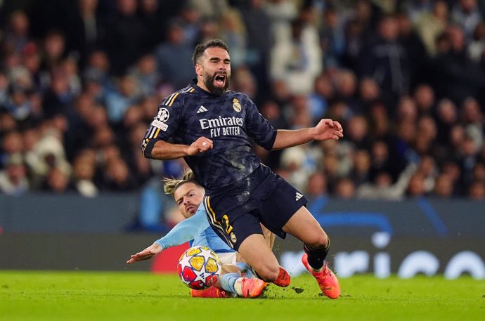 17 April 2024, United Kingdom, Manchester: Manchester City's Jack Grealish (L) fouls Real Madrid's Dani Carvajal (R) during the UEFA Champions League quarter-final second leg soccer match between Manchester City and Real Madrid at the Etihad Stadium, Manc