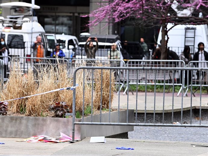 April 19, 2024, New York, New York, USA: In the aftermath of a man setting himself on fire, the FDNY inspect the scene where this took place in the park across from the NYS Criminal Courthouse. Left behind are the remnants of the disaster, including the g