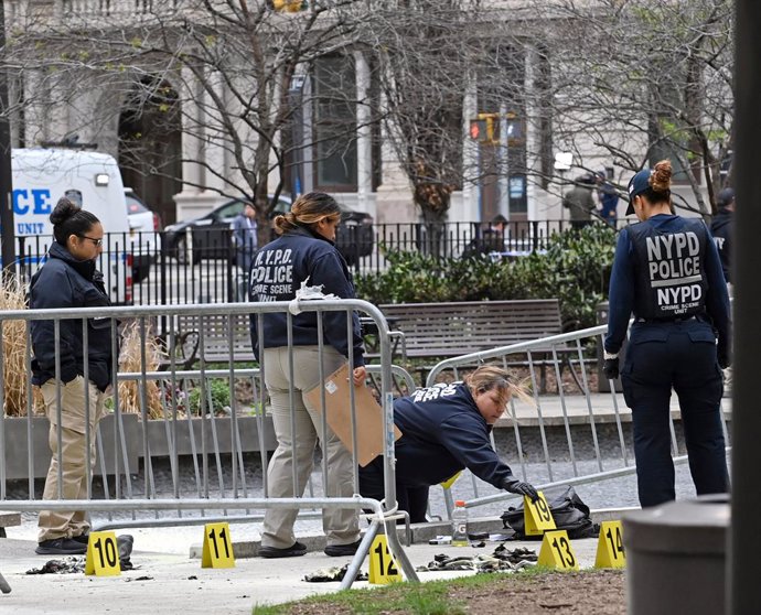 19 April 2024, US, New York: Members of New York City Fire Department (FDNY) inspect the scene in the aftermath of a man setting himself on fire, in the park across from the NYS Criminal Courthouse. According to US media reports, a man set himself on fire