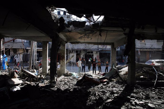GAZA, April 17, 2024  -- People inspect a destroyed house in the southern Gaza Strip city of Rafah, on April 17, 2024. The Palestinian death toll in the Gaza Strip from ongoing Israeli attacks has risen to 33,899, the Hamas-run Health Ministry said in a p