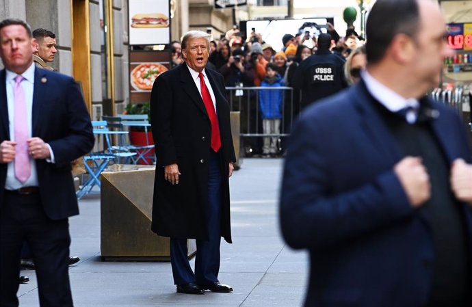 25 March 2024, US, New York: Former US president Donald Trump steps out of 40 Wall Street following his press conference after a pre-trial hearing at Manhattan criminal court.  A criminal trial against former US president Donald Trump in New York over all