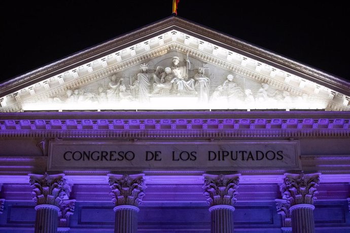 Archivo - La fachada del Congreso de los Diputados iluminada de color morado, a 25 de noviembre de 2023, en Madrid (España).   