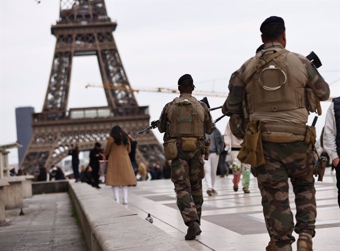 PARIS, March 25, 2024  -- Armed French soldiers patrol at the Trocadero place near the Eiffel Tower in Paris, France, on March 25, 2024. The French government decided on Sunday to raise the national security alert system Vigipirate to its highest level to