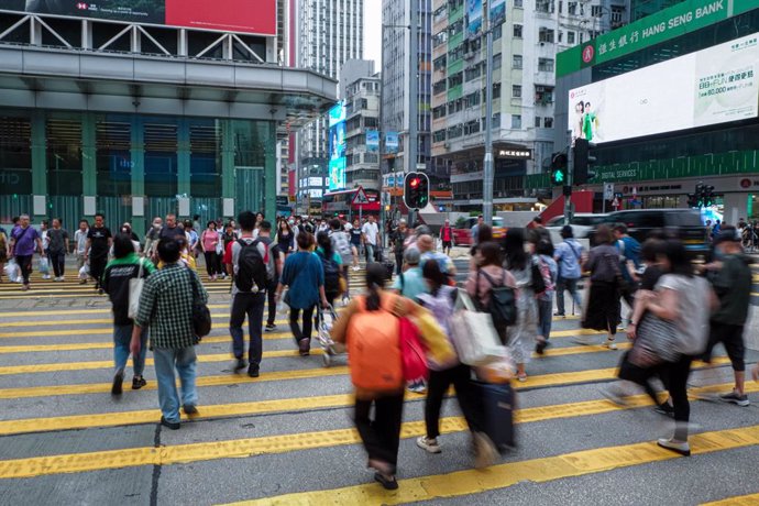 April 24, 2024, Hong Kong, China: Local Hong Kong people cross a street in a busy district.
