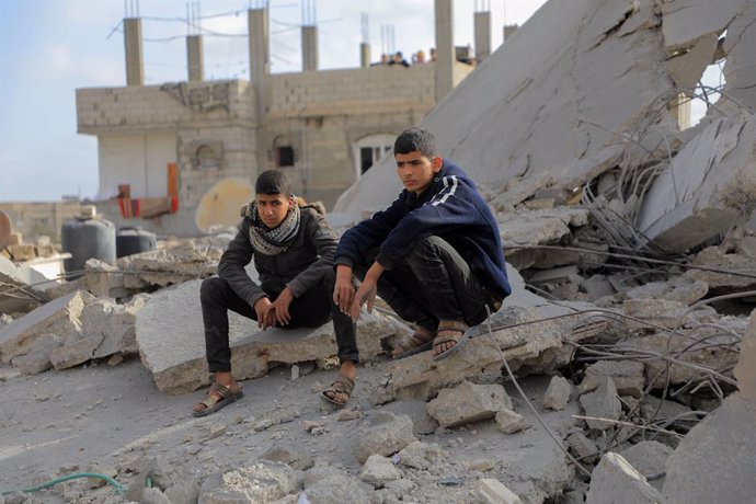 GAZA, April 22, 2024  -- Two men sit among rubble of destroyed buildings after an Israeli airstrike in the southern Gaza Strip city of Rafah, April 21, 2024. The Palestinian death toll from ongoing Israeli attacks on the Gaza Strip has risen to 34,097, th