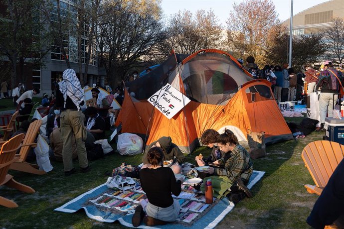 April 25, 2024, Boston, Massachusetts, United States: Student protesters at the Northeastern University encampment sit by tents at the Centennial Common. Students are demanding their university divest from the Israeli government and companies. Earlier in 