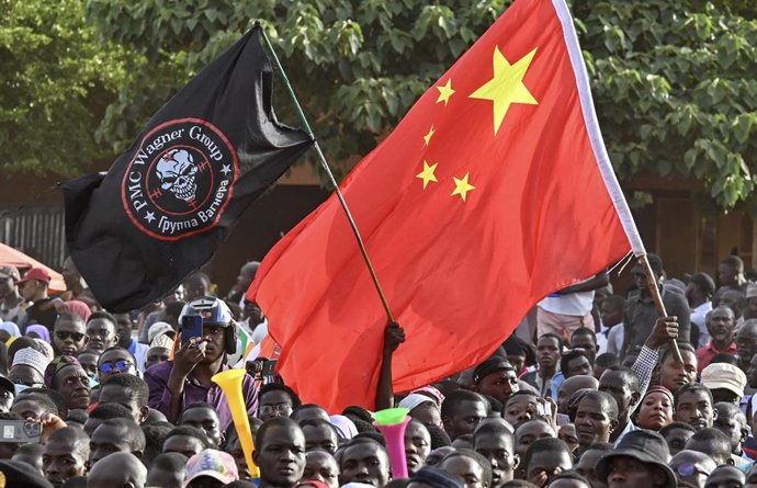 Turning away from the West towards Russia and China: Supporters of Niger's National Council of Safeguard of the Homeland (CNSP) wave the Chinese flag and flag bearing the logo of private military Company Wagner, in Niamey on September 16, 2023. 