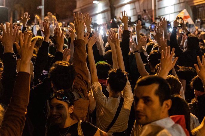 April 28, 2024, Tbilisi, Georgia: Protesters rise their hands up in front of the police during a protest against the reintroduction of a bill on ''foreign agents'' in central Tbilisi.