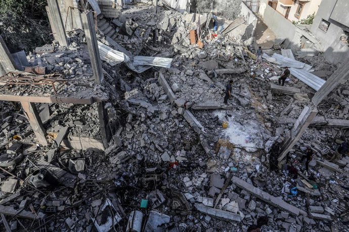 24 April 2024, Palestinian Territories, Rafah: Palestinians inspect a house that was destroyed after an Israeli aircraft bombed a home for the Al-Bakhabsa family, resulting in the death of 3 people and several wounded, in the city of Rafah, southern of th
