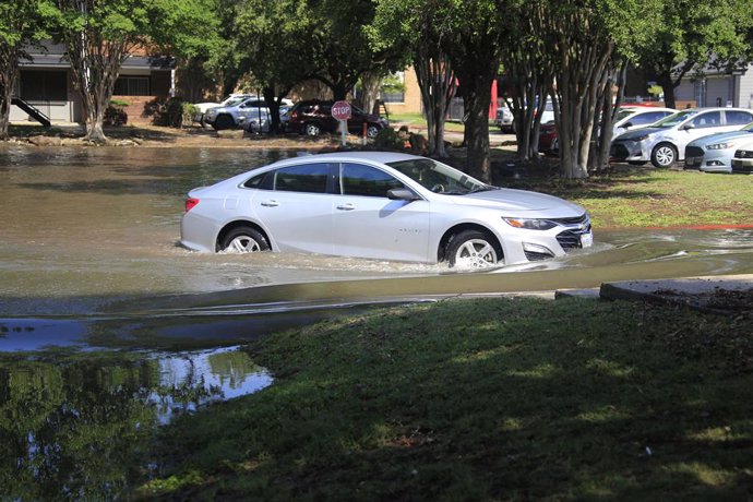 TEXAS, May 3, 2024  -- A car is seen in floodwaters in a residential area in Spring, Texas, the United States, May 2, 2024. Multiple rounds of thunderstorms are worsening flooding threats on Thursday across eastern Texas, including the Houston area, forci