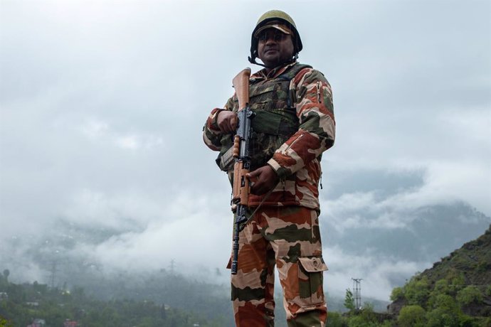April 19, 2024, Banihal, India: An Indian paramilitary soldier stands on guard outside a polling station amidst rainfall during the first phase of the Lok Sabha, or lower house, of the Indian parliamentary elections in a hilly village in Banihal, an area 