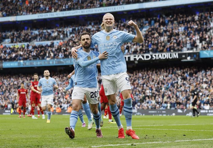 04 May 2024, United Kingdom, Manchester: Manchester City's Erling Haaland (R) celebrates scoring his side's first goal with teammate Bernardo Silva during the English Premier League soccer match between Manchester City and Wolverhampton Wanderers at the E