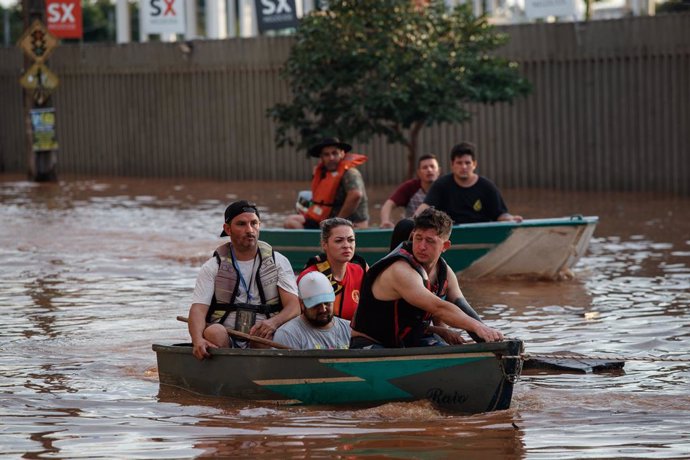 BRAZIL, May 6, 2024  -- This photo taken on May 5, 2024 shows rescue team members evacuating people affected by flood in Novo Hamburgo, Rio Grande do Sul, Brazil. At least 75 people have died from severe storms that inundated large swaths of south Brazil'