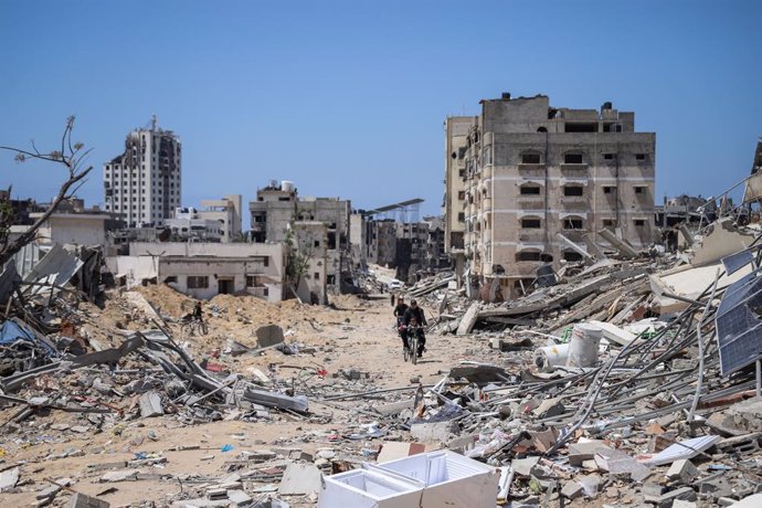 GAZA, April 14, 2024  -- People ride past debris in Gaza City, April 13, 2024. The Islamic Resistance Movement (Hamas) announced Saturday it has responded to mediators in Egypt and Qatar over the proposed ceasefire in the Gaza Strip and reaffirmed its dem