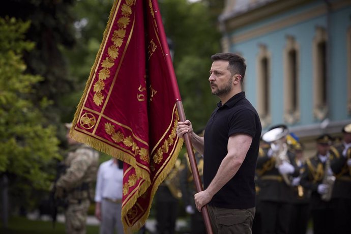 May 6, 2024, Kyiv, Kiev Oblast, Ukraine: Ukrainian President Volodymyr Zelenskyy, right, awards a battle flag to hero military units during Infantry Day celebrations on Constitution Square, May 6, 2024, in Kyiv, Ukraine.