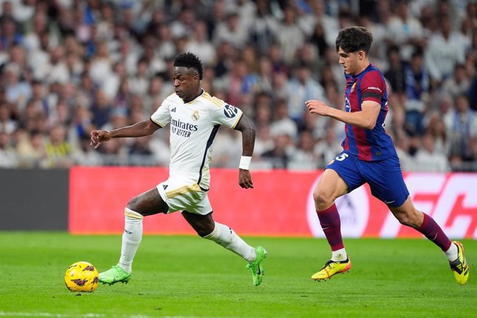 Vinicius Junior of Real Madrid and Pau Cubarsi of FC Barcelona in action during the Spanish League, LaLiga EA Sports, football match played between Real Madrid and FC Barcelona at Santiago Bernabeu stadium on April 21, 2024 in Madrid, Spain.